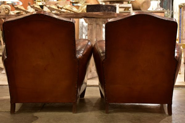 Pair of vintage French leather club chairs with - chapeau gendarme on Sale