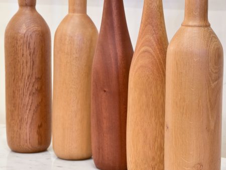 Collection of five wooden sculptures in the shape of bottles For Sale