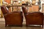 Pair of vintage French leather club chairs with - chapeau gendarme on Sale