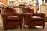 Pair of vintage French leather club chairs with - chapeau gendarme on Sale